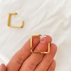 No piercing? No problem. Allergic to all metals? We got you. Introducing our newest line of clip on earrings, that will work for all types of skin types and hole-less lobes. Description: Clip-on piece has our resin, bendable piece to fit around your earlobe Metal: 18K Gold plated Stainless Steel Size: 22mm x 8mm Weight: 3g for one earring Minimalist Metal Clip-on Earrings For Gift, Trendy Gold Piercings For Gift, Modern Hoop Clip-on Earrings As Gift, Hypoallergenic Metal Cartilage Earrings As Gift, Elegant Hypoallergenic Metal Piercings, Modern Metal Cartilage Earrings For Gifts, Modern Metal Cartilage Earrings As Gift, Hypoallergenic Small Hoop Gold Plug Earrings, Gold Metal Cartilage Earrings As A Gift