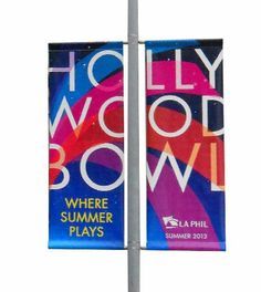 there are two banners that say hollywood bowl and where summer plays on the same pole