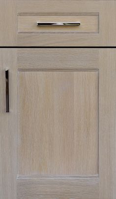 a close up of a wooden cabinet door with a handle on the front and bottom