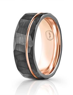 the black and rose gold wedding band is shown with an intricate design inlayed to it