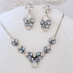 Elegant Vintage style Bridal Necklace. Made with high-quality Swarovski crystals in light blue and white opal, finished with a delicate silver chain. All designed and made by me in my SimplyChic studio. The length of the necklace is 16inches plus a 2-inch extension chain for flexible length. Matching earrings at this link: https://www.etsy.com/listing/718592806/sapphire-light-blue-statement-earrings?ref=shop_home_active_118&pro=1&frs=1 https://www.etsy.com/listing/797029875/sapphire-ligh Dusty Blue Necklace, Blue Jewelry Aesthetic, Blue Jewlery, Light Blue Jewelry, Light Blue Earrings, Light Blue Necklace, Blue Statement Earrings, Blue Stones Jewelry, Blue Jewellery