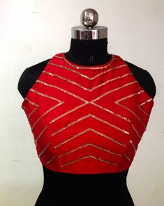 Red raw silk blouse with beautiful front and back geometric embroidery. The blouse will be made to order. You can specify the ready blouse size or you can share your custom measurements. I'll share a detailed measurement chart once you place the order. Matching saree listing: https://www.etsy.com/listing/939604188/copper-fern-leaf-sequin-embroidery-on Halter Neck Saree Blouse Front And Back, Festive Tops With Geometric Embroidery, Festive Red Mirror Work Tops, Red Mirror Work Top For Wedding, Embroidered Sleeveless Blouse For Parties, Red Wedding Top With Mirror Work, Red Embellished Sleeveless Top, Red Blouse With Geometric Embroidery, Traditional Red Tops With Geometric Embroidery