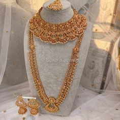 Luxury Bright gold polished champagne zircon full bridal set with small champagne pearl beads. Bridal set includes, Necklace, Long mala, Earrings and tikka This set is ready to ship as seen with gift box. Gold Sets With Pallu For Marriage, Gold Festive Sets For Marriage, Gold Sets With Intricate Design For Reception, Gold Jewelry With Zari Work For Gifts, Gold Bollywood Lehenga For Marriage, Gold Bollywood Traditional Wear For Marriage, Bollywood Style Gold Lehenga For Marriage, Gold Temple Jewelry Bridal Accessories With Stone Work, Gold Temple Jewelry Bridal Accessories