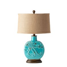 a blue lamp with an octopus design on it and a light shade over the top