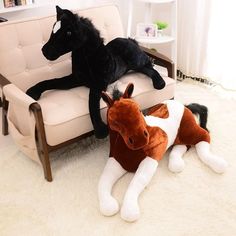 two stuffed animals sitting on top of a couch