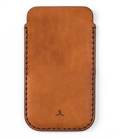 a brown leather case with stitching on the front and side, sitting on a white surface