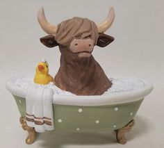 a statue of a bull in a bathtub with a rubber duck