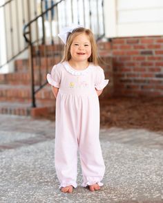 Our Betsy knit romper features adorable embroidered Zoo animals. Made of a soft yarn-dyed pale pink stripe knit includes ruffles at the neck, sleeves and ankles trimmed in pink picot. Elastic at ankles with diaper snaps for easy changing. Runs true to size. Model is wearing size 2. Coordinates with the Light Blue Stripe Collection. This garment is made with pre-shrunk cotton knit. Spring Ruffled Onesie For Loungewear, Spring Loungewear Onesie With Ruffles, Pink Ruffled Onesie For Playwear, Casual Pink Onesie With Ruffles, Pink Onesie For Loungewear In Spring, Pink Onesie For Spring Loungewear, Casual Pink Onesie For Spring, Casual Onesie For Spring Sleepover, Pink Casual Bubble Romper With Ruffles