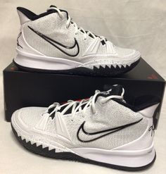 a pair of white and black nike basketball shoes