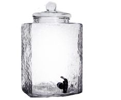 a glass jar filled with water on top of a white background