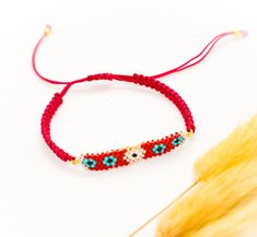 This red Macramé bracelet features a beaded evil eye bar made with red, blue, white, gold, and black Miyuki beads and a red nylon cord.  It would make a great gift for your best friend or simply to treat yourself. This beaded bracelet closes with a handmade macramé knot that makes it suitable for everyone. Wear it on its own or combine it with others for a boho casual look. SIZE Adjustable (14" to 18") A D D I T I O N A L    I N F O R M A T I O N                        ❤️PLEASE KEEP YOUR ITEMS a Women Protection, Bracelet Miyuki, Evil Eye Design, Bar Bracelet, Macrame Knot, Gift For Best Friend, Miyuki Beads, Eye Bracelet, Bar Bracelets