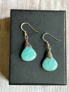 "Handmade wire wrapped Larimar suspended from .925 sterling silver French ear wires.  These earrings have been hand wire wrapped with sterling silver 26 gauge wire.  Earring Measurements:  1 1/2\" long by 1/2\" wide.  The stone is natural Larimar,  which is only found in the Dominican Republic.  Another name for the stone is called the Atlantis stone for its striking aqua blues reminiscent of the Caribbean sea and the lost city of Atlantis. Larimar is a rare form of Blue Pectolite. If you would Amazonite Drop Earrings As Gift, Hypoallergenic Amazonite Jewelry As Gift, Dangle Earrings With Amazonite And Natural Stones, Amazonite Natural Stone Earrings For Gifts, Handmade Turquoise Amazonite Earrings, Sterling Silver Natural Stones Teardrop Earrings, Silver Larimar Dangle Earrings, Handmade Dangle Amazonite Earrings, Handmade Amazonite Dangle Earrings