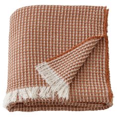 an orange and white checkered blanket with fringes