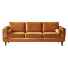 a brown leather couch with two pillows on the armrests and one pillow in the back