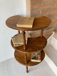 three tiered wooden table with books on top