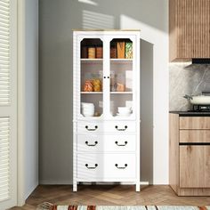 a white cabinet with drawers in a kitchen