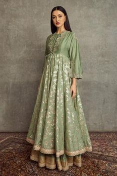 Mint green layered anarkali with front tie-up, lace borders, banarasi woven motifs and floral placement embroidery.
Component: 1
Pattern: Embroidered, Woven
Type Of Work: Floral
Neckline: Loop Neck
Sleeve Type: Long Sleeves
Fabric: Chanderi Banaras
Color: Green
Other Details: 
Front tie-up
Floral motifs
Occasion: Sangeet, Mehendi - Aza Fashions Placement Embroidery, Stylish Maxi Dress, Floral Frocks, Anarkali Dress Pattern, Latest Dress Design, Frock Fashion, Frock For Women, Frock Dress, Indian Dresses Traditional