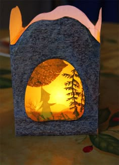 a paper lantern with an image of a horse in the middle and trees on it