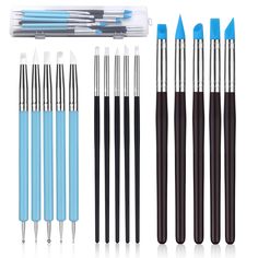 an assortment of different types of pens and pencils on a white background with blue tips