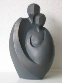 a gray vase sitting on top of a white table