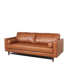 a brown leather couch with two pillows on it's arms and backrests