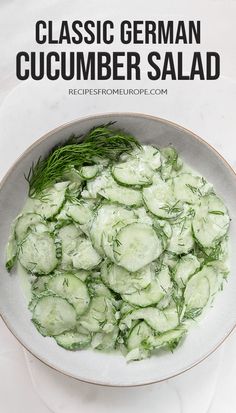 a bowl filled with cucumber salad on top of a white table