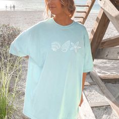 This t-shirt is everything you've dreamed of and more. It feels soft and lightweight, with the right amount of stretch.  It's the perfect beach vacation tee.  Wear is as a coverup over your swimsuit or pair it with some summer shorts.   For an oversized look, size up 1-3 sizes. * 100% combed and ring-spun cotton (Heather colors contain polyester) * Fabric weight: 4.2 oz/yd² (142 g/m²) * Pre-shrunk fabric * Side-seamed construction * Shoulder-to-shoulder taping * Blank product sourced from Guatemala, Nicaragua, Mexico, Honduras, or the US Casual Ocean Color Beach Tops, Casual Ocean Color Tops For Beach, Casual Ocean Color Crew Neck T-shirt, Oversized Beachy Crew Neck Tops, Beachy Oversized Short Sleeve Tops, Relaxed Fit Short Sleeve T-shirt For Beach Season, Beachy Oversized Graphic Print T-shirt, Oversized Beachy T-shirt With Graphic Print, Oversized Blue T-shirt For Beach Season