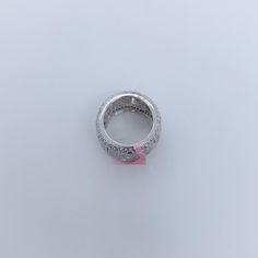 a white gold diamond ring with pink ribbon