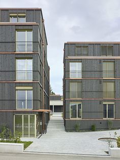 two apartment buildings with balconies on each floor