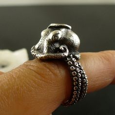 an octopus ring is shown on someone's finger