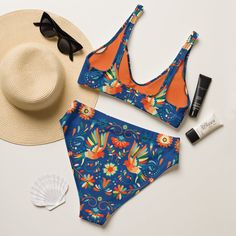 Inspired by the rich culture and intricate designs of Mexico's Otomi artwork, our Recycled High-Waisted Bikini features a stunning print against a deep blue backdrop. Dive into style and sustainability with this eco-friendly swimwear! Perfect for lounging by the pool or catching waves at the beach, this bikini combines fashion with environmental consciousness. Get ready to make a splash while paying homage to Mexican artistry! It’s too easy to fall in love with this bikini set. Removable pads and its double-layer make it comfy to wear all day by the pool or at the beach.This bikini is destined to become the only swimsuit you'll want to reach for in your drawer! The bottoms are high-waisted, and the top has removable pads. Both come with a tear-away care label. Made of recycled materials (l Blue Swimwear With Bold Print For Beach, Multicolor High Waist Printed Swimwear, High Waist Multicolor Printed Swimwear, Multicolor Printed High Waist Swimwear, Multicolor Printed High-waist Swimwear, Vibrant Blue Printed Swimwear, Blue Swimwear With Vibrant Print, Blue Swimwear With Bold Print For Vacation, Blue Bold Print Swimwear For Vacation