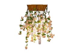 a chandelier with white flowers hanging from it's sides and green leaves