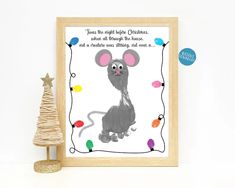 a christmas card with a drawing of a mouse on it and a small tree next to it