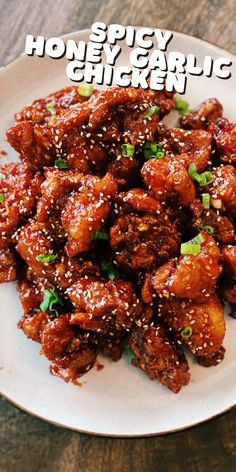 a white plate topped with chicken covered in sesame seeds