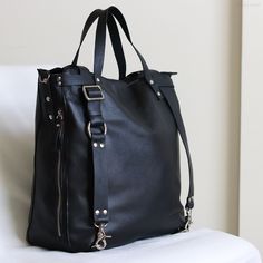 "Phoenix is a convertible backpack and crossbody tote bag. The size fits Macbook 13\" and 15\" The tote is made of the full-grain black leather for bag and matte black belt leather for straps, the strap leather feels very nice on the shoulders and doesn't slide over. The tote is perfect as an everyday bag, it's very spacious but doesn't look huge. Measurements height 14\", width about 13.5-14\", depth on the bottom about 4.5\" and 3\" on the top. The top handles drop 5\" (12.7cm) The top handles Full Grain Leather Bag, Suede Backpack, Macbook 13, Brown Leather Backpack, Large Crossbody Bags, Vintage Backpacks, Convertible Backpack, Black Leather Backpack, Convertible Bags