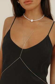 Our first ever body chain is here to stay, featuring an elongated flat box chain in 14k gold-filled. Created to delicately wrap you, this body chain is meticulously crafted with precision and care &  is the epitome of timeless luxury. Wear the Tara body chain all year round - over a slip dress, a bikini, with jeans or your favorite slip dress.

Chain Dimensions: 1.2mm flat box
Measurements: 23” Necklace & 30” Waist
Waterproof & tarnish resistant Elegant White Gold Chain Necklace For Party, Minimalist Rose Gold Double Chain Jewelry, Elegant Pearl Chain Jewelry For Parties, Elegant Gold Plated Chain Necklace With Adjustable Chain, Elegant Chain Necklace For Wedding, Elegant White Gold Lariat Chain Necklace, Elegant Rose Gold Double Chain Necklace, Double Chain Lariat Jewelry For Party, Classic Chain Necklace With Adjustable Chain For Party