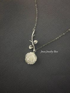 Sweet white shell rose and silver branch necklace. Very dainty but sturdy. White shell rose is double sided and 12mm wide. Silver branch and rose are on an 18'' stainless steel chain with lobster clasp. *Stainless steel chain *Silver brass branch *12mm Shell rose *Handmade with love <3 Like Jmesjewelrybox on Facebook for updates on new jewelry, upcoming sales and giveaways! Plus Facebook fans save 5% :D Find the coupon code on Jmesjewelrybox's cover photo https://www.facebook.com/Jmesjewelryb Sterling Silver Rose Design Necklace For Weddings, Silver Flower-shaped Necklace With Rose Design, Silver Dainty Necklace With Rose Design, Dainty Silver Jewelry With Rose Design, Dainty Silver Necklace With Rose Design, Dainty Silver Necklaces With Rose Design, Dainty Silver Rose Design Necklaces, Silver Flower Necklace With Rose Design For Gift, Silver Rose Design Flower Necklace As Gift