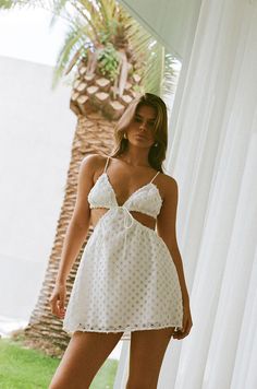 Inspired by European summers, the Toulouse Mini Dress is made from a structured lace fabric in white. It is a backless style featuring tri cups with a draw tie at centre bust, elasticated cutouts at waist with and a flouncy mini skirt. Dress it up with the Lalita Heels or keep it casual with the slides. Designed exclus Mini Skirt Dress, Women's Fashion Set, Jumpsuit Chic, Stunning Outfits, Spring Fashion Trends, Spring Outfits Women, Dress For Short Women, Outfits Women, Lace Mini Dress