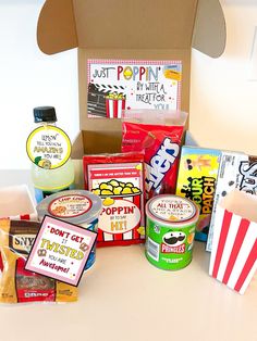 an open box filled with popcorn and snacks