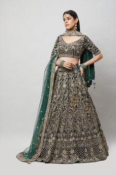 Entirely handcrafted with zardosi and crystal embroidery, this emerald green lehenga is a stunner! Fabric: Net with satin lining All preorders will be handled by a Nazranaa Bridal Consultant who will virtually discuss measurements and minor changes according to the client's specifications Occasion: Wedding Reception WASH CARE INSTRUCTIONS - Please Dry clean only when it is applicable. Slight color variation is possible due to digital photography. Jewelry not included Navratri Green Embellished Lehenga, Green Embellished Lehenga For Navratri, Embellished Green Lehenga For Navratri, Green Embellished Traditional Wear For Navratri, Embellished Green Traditional Wear For Navratri, Anarkali Embellished Green Choli, Anarkali Style Embellished Green Choli, Green Embellished Anarkali Choli, Green Embellished Traditional Wear For Reception