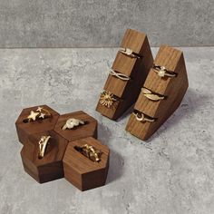 three wooden boxes with rings on them sitting on the floor next to each other,