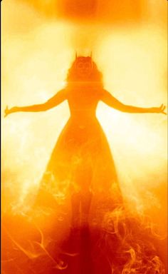 a woman with her arms outstretched in front of an orange and yellow background that appears to be fire