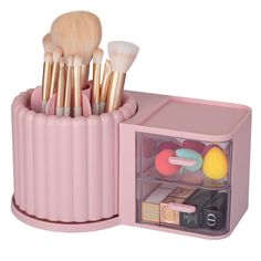 the makeup brush holder is pink and has five different brushes in it, including one for eyeshades