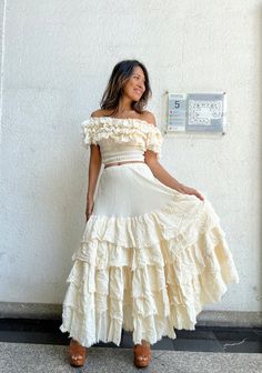 Bohemian ruffle maxi cream skirt with un finish hem and each layer. Elastic waist 100% raw cotton. Lined. Color Cream and White Handmade ruffle off shoulder blouse. Un finished hem at all the layers. Smock under a bust and waist. 100% natural cotton. Can be worn as a cover and off shoulder and one side shoulder styles. 2 colors. Cream White. Model 5'6 Measurements: TOP Bust 30 up to 50 inches. Shoulder elastic 30 up to 65 inches. Waist 22 up to 46 inches. Length 14.5 inches. Measurements: for th Tiered Dress With Lined Skirt, Flowy Tiered Dress With Lined Skirt, Flowy Lined Tiered Dress, Flowy Floor-length Dress With Ruffled Skirt, Ruffled Flowy Maxi Dress For Wedding, Summer Floor-length Ruffled Maxi Skirt, Cream Maxi Length Dress With Flowy Skirt, Cream Maxi Dress With Flowy Skirt, Cream Ruffled Skirt