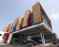 a multicolored building with cars parked in front