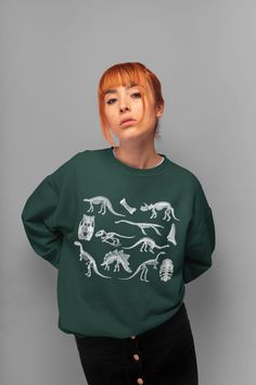 Dinosaur Sweatshirt Skeletons Sweater Goblincore Clothing Aesthetic Clothing Dark Academia Pullover Dino Sweatshirt Dino Crewneck Sweater. Sweatshirt features: *Made from 50% cotton, 50% polyester (heathers colors are 40% cotton, 60% polyester) *Medium-heavy fabric (8.0 oz/yd² (271.25 g/m *Loose fit *Oversized if you choose 1-2 sizes bigger *Sewn-in label *Runs true to size *Crewneck *Unisex style *Ribbed knit collar *Without itchy side seams Canvas Tote Bag features (available in black color): Casual Dinosaur Print Tops For Fall, Casual Green Dinosaur Print Tops, Casual Green Tops With Dinosaur Print, Long Sleeve Top With Dinosaur Print For Fall, Cotton Tops With Dinosaur Print For Fall, Cotton Top With Dinosaur Print For Fall, Casual Dinosaur Print Crew Neck Sweatshirt, Dinosaur Print Long Sleeve Tops For Winter, Casual Dinosaur Print Tops For Streetwear