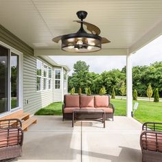 a patio with couches, chairs and a ceiling fan on the side of it