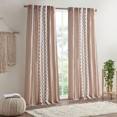 a living room with a white rug and pink curtains