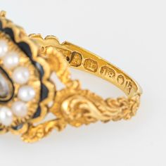 Antique Georgian era memorial ring (circa 1825) crafted in 18 karat yellow gold.   Natural pearls measuring (average) 2.5mm border an oval compartment that holds natural hair. The pearls are in very good condition showing good lustre. The glass case protecting the braided hair is in excellent condition and free of cracks or crisps.       The ring is a wonderful example of Georgian era memorial jewellery with rich floral and scrolled details to the side shoulders. The pearls border a lock of hair Victorian Oval Jewelry For Opera, Antique Enamel Wedding Ring, Antique Yellow Gold Pearl Ring With Rose Cut Diamonds, Antique Yellow Gold Enamel Ring, Yellow Gold Oval Jewelry For Opera, Victorian Gold Enamel Ceremonial Ring, Antique Gold Enamel Ring With Rose Cut Diamonds, Antique Yellow Gold Enamel Ring For Ceremonies, Victorian Hallmarked Enamel Ring For Wedding