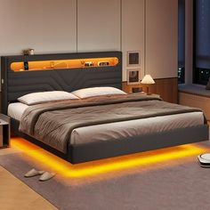 a bedroom with a large bed that has yellow lights on the headboard and foot board